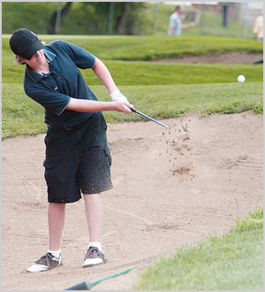 A golf player hitting a ball