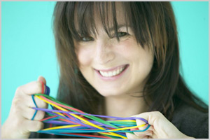 A woman stretching rubber bands