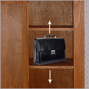 A leather bag on a shelf in a cupboard